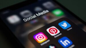 Smartphone showing social media apps used to run HVAC Facebook and Instagram ads