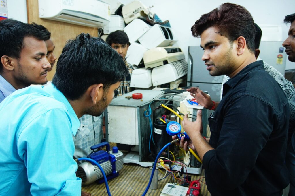 Trainees learning air conditioning repair in a hands-on session