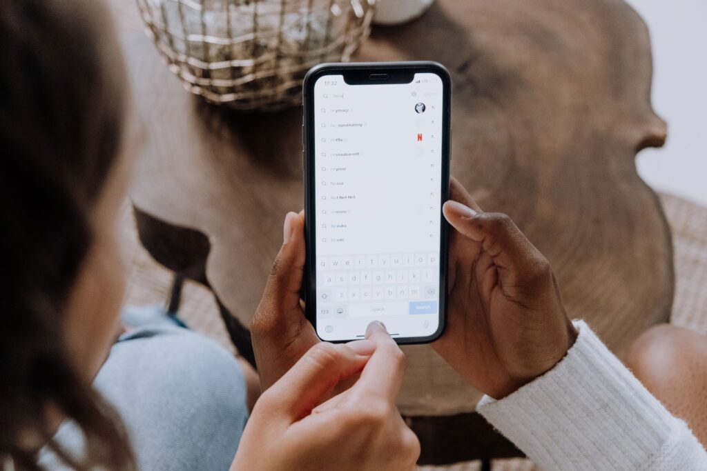 Hands searching on a smartphone, how most HVAC searches actually start