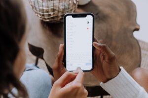 Hands searching on a smartphone, how most HVAC searches actually start