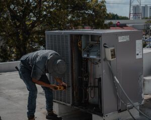 HVAC technician servicing a rooftop unit, the work a service page has to sell
