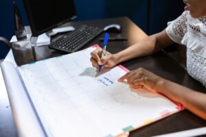Marking dates on a desk calendar to plan seasonal HVAC content