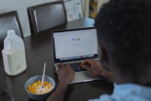 Homeowner researching a contractor on a laptop at the kitchen table