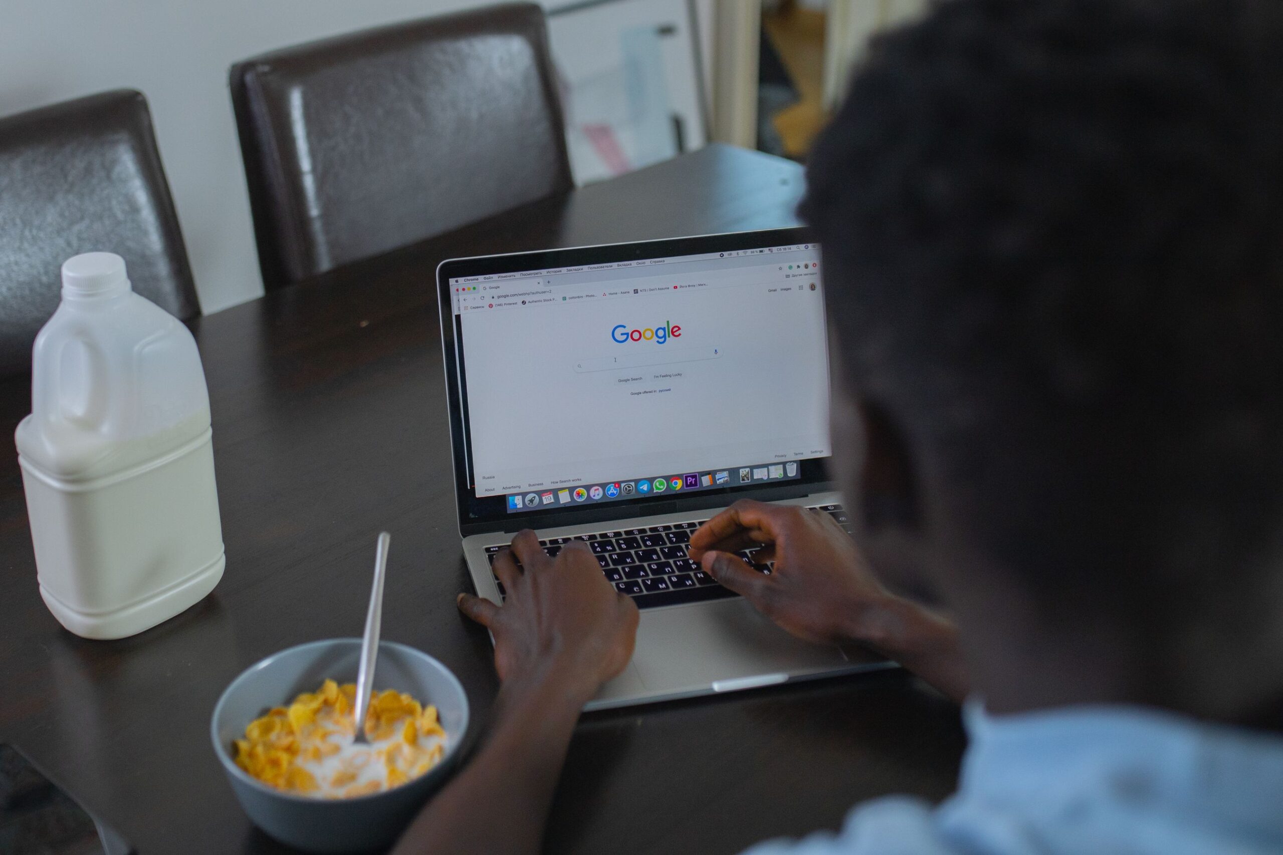 Homeowner researching a contractor on a laptop at the kitchen table