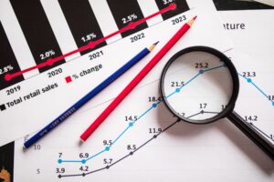 Magnifying glass over financial growth charts, the figures behind an HVAC company valuation